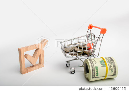 Wooden checkbox and a cart with money.  43609435