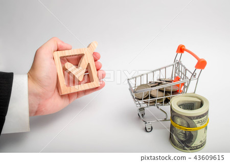 The businessman's hand holds a wooden checkbox  43609615