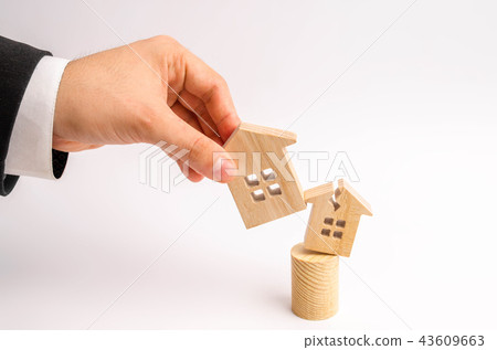 The businessman's hand replaces the broken house The businessman's hand replaces the broken house 43609663