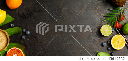 Cocktail making bar tools, tropical fruits and leaves on a dark  43610532