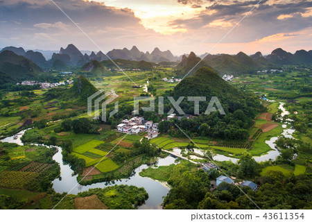 Stunning sunset over karst formations landscape near Yangshuo Ch 43611354