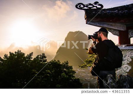 Photographer capturing sunrise over karst rocks in Yangshuo Chin 43611355