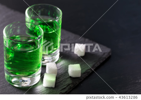 Two glasses of strong absinthe and sugar Two glasses of strong absinthe and sugar 43613286