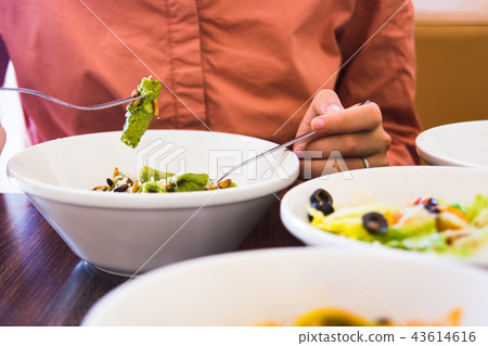 Female eating pasta in the restaurant Female eating pasta in the restaurant 43614616