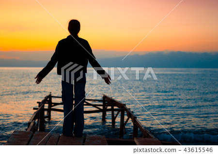 girl on the dock at sunset 43615546