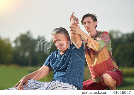 Thai massage, stretching arm. Thai massage, stretching arm. 43616067