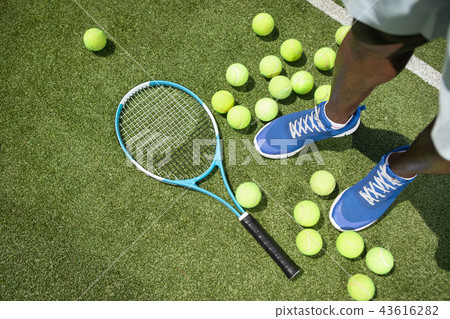 Man is using tennis equipment Man is using tennis equipment 43616282