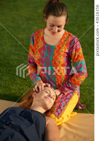 Thai therapy head massaging outdoor. Thai therapy head massaging outdoor. 43616356