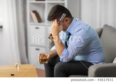 alcoholic with bottle drinking whiskey at home alcoholic with bottle drinking whiskey at home 43617631