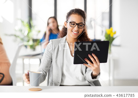 businesswoman with tablet pc and coffee at office 43617785
