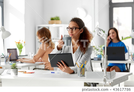 businesswoman with tablet pc and coffee at office 43617786