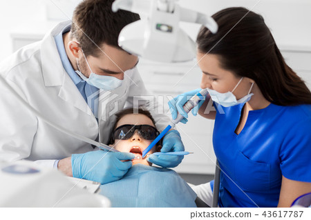 dentist treating kid teeth at dental clinic 43617787
