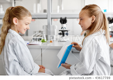 girls with notebook at laboratory 43617789
