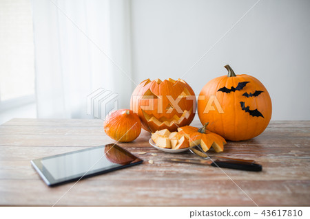 halloween jack-o-lantern, pumpkins and tablet pc halloween jack-o-lantern, pumpkins and tablet pc 43617810