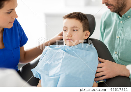 father and son visiting dentist at dental clinic father and son visiting dentist at dental clinic 43617811