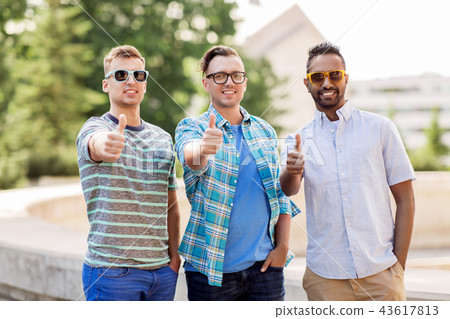 happy young men in sunglasses showing thumbs up happy young men in sunglasses showing thumbs up 43617813