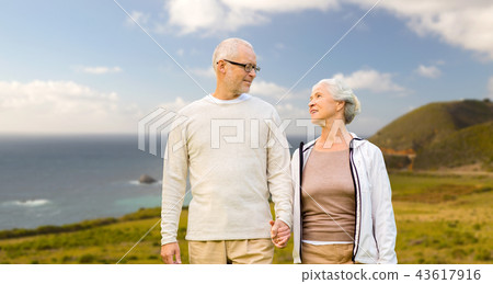 happy senior couple over big sur coast 43617916