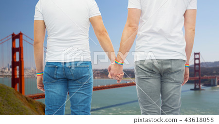 male couple with gay pride rainbow wristbands 43618058