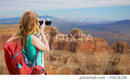 woman with backpack and camera at grand canyon woman with backpack and camera at grand canyon 43618196