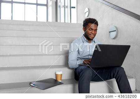 african american businessman with laptop at office african american businessman with laptop at office 43618200