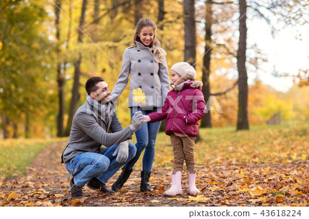 happy family with maple leaf at autumn park happy family with maple leaf at autumn park 43618224