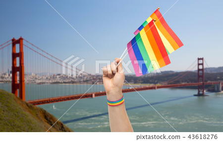 hand with gay pride rainbow flags and wristband 43618276