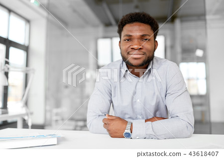 smiling african american businessman at office 43618407