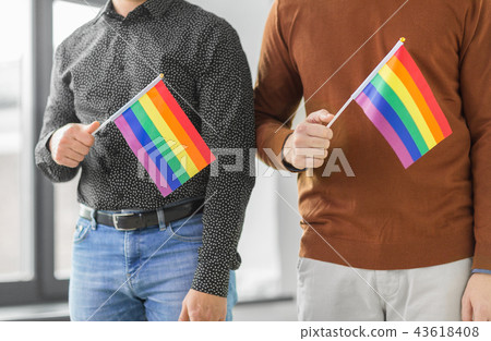 close up of male couple with gay pride flags 43618408
