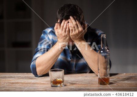 alcoholic with bottle drinking whiskey at night 43618412