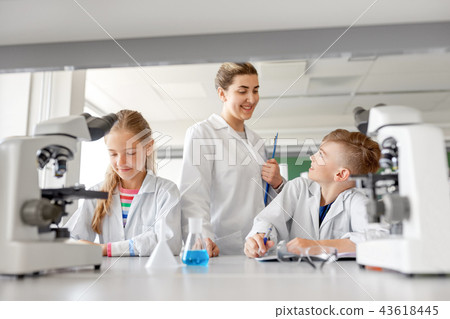 teacher and students studying chemistry at school 43618445