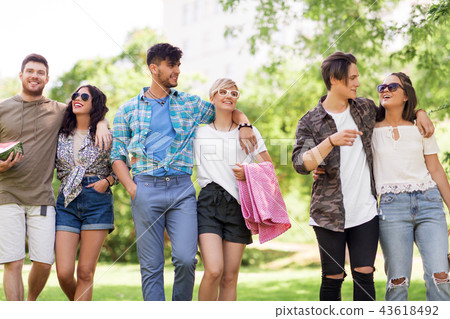 happy friends with picnic blanket at summer park 43618492