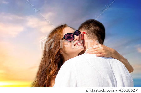 happy couple hugging over sunset sky background 43618527