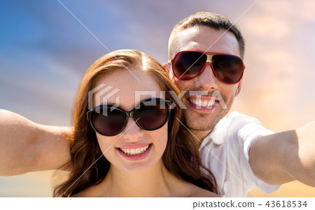 smiling couple wearing sunglasses making selfie smiling couple wearing sunglasses making selfie 43618534