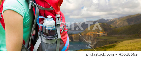 close up of woman with water bottle in backpack 43618562