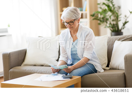 senior woman counting money at home senior woman counting money at home 43618651
