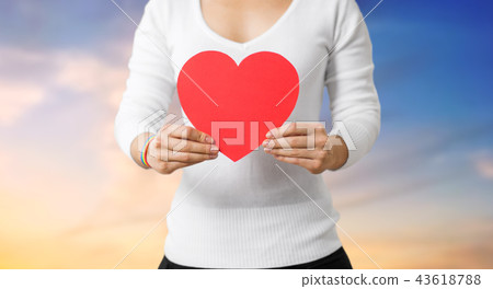 woman with gay awareness wristband holding heart woman with gay awareness wristband holding heart 43618788