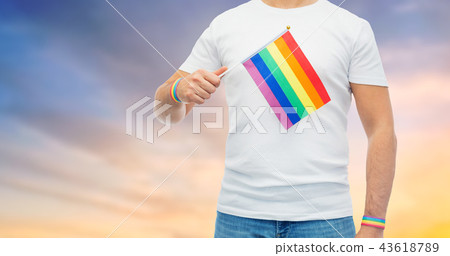 man with rainbow flag and gay pride wristbands man with rainbow flag and gay pride wristbands 43618789