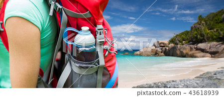 close up of woman with water bottle in backpack 43618939