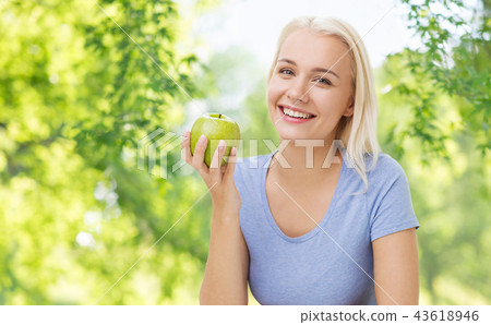 happy smiling woman with green apple happy smiling woman with green apple 43618946