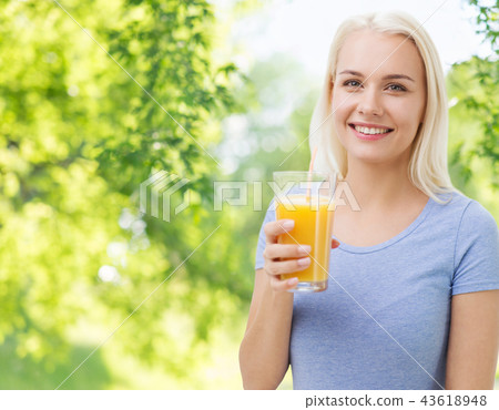 smiling woman drinking orange juice or fresh smiling woman drinking orange juice or fresh 43618948