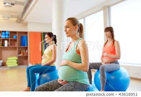 pregnant women sitting on exercise balls in gym pregnant women sitting on exercise balls in gym 43618951