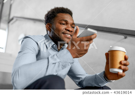 businessman records voice by smartphone at office businessman records voice by smartphone at office 43619014
