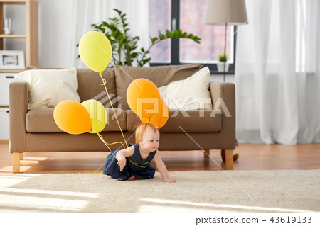 lovely redhead baby girl with balloons at home lovely redhead baby girl with balloons at home 43619133