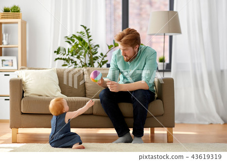 father playing with little baby daughter at home father playing with little baby daughter at home 43619319