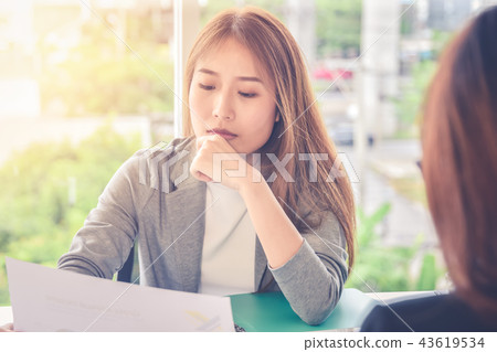 Woman submits an application form to an interviewer,Applying for new job,career opportunity concept 43619534