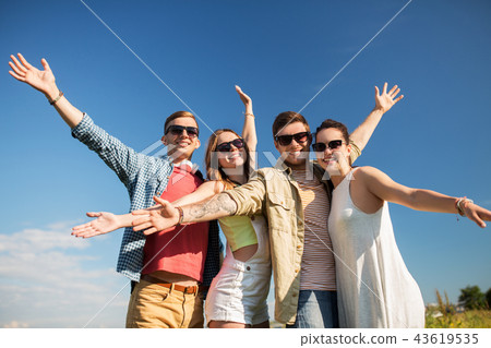 happy teenage friends outdoors in summer happy teenage friends outdoors in summer 43619535