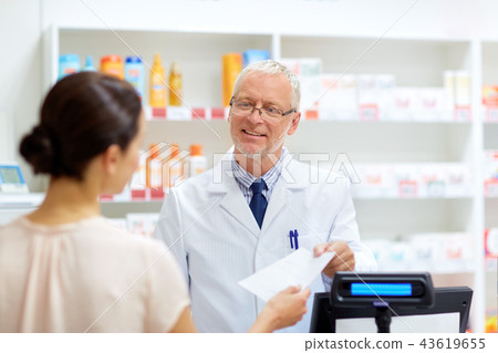 senior apothecary with prescription at pharmacy 43619655