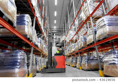 male loader operating forklift at warehouse 43619656