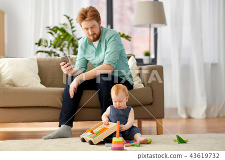 father and baby playing with toy blocks at home 43619732