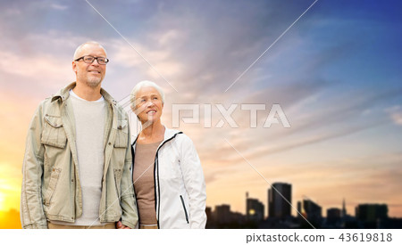 senior couple hugging over evening tallinn city 43619818